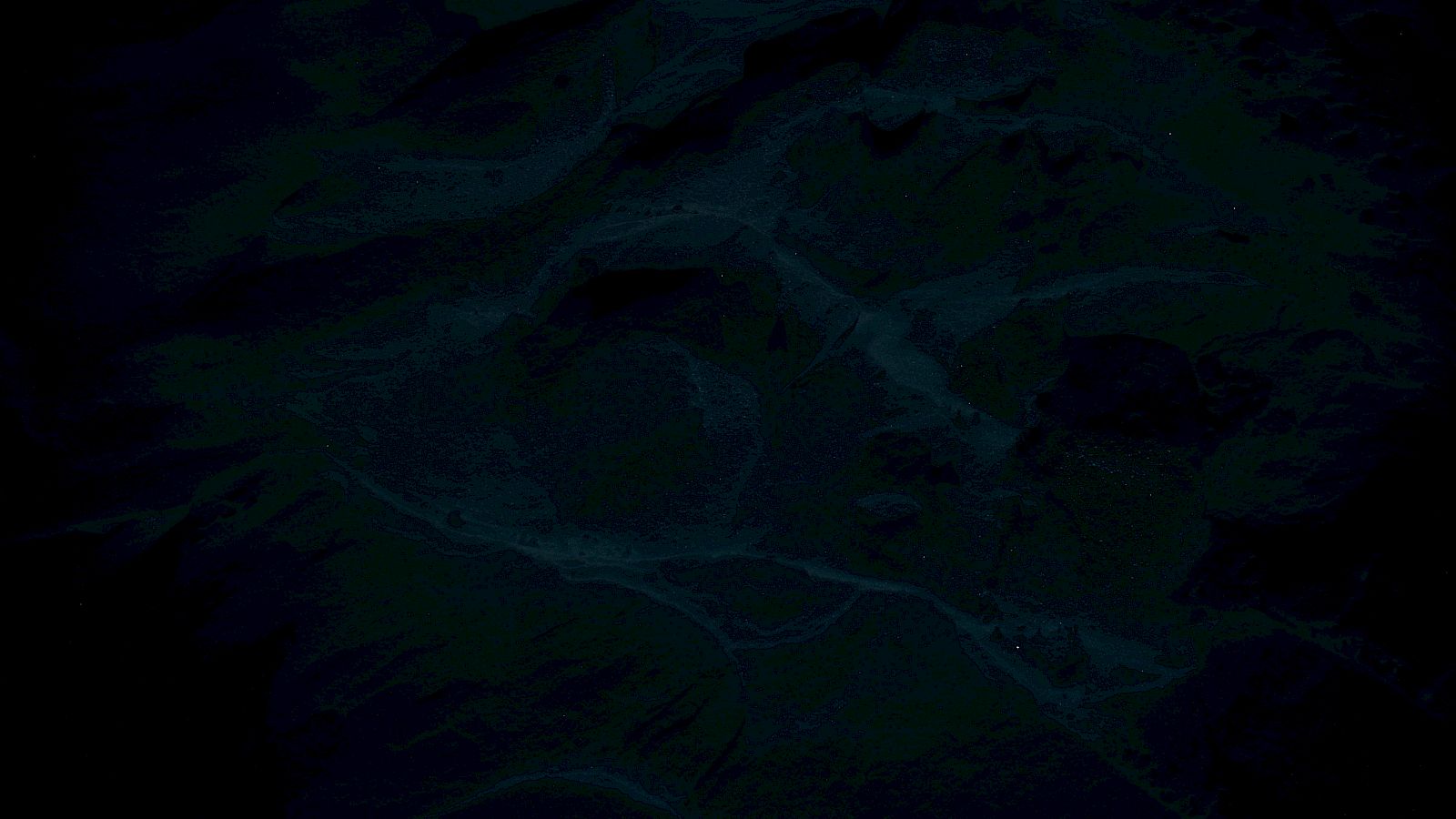 The image is very dark, with indistinct shapes and patterns that are difficult to discern clearly.